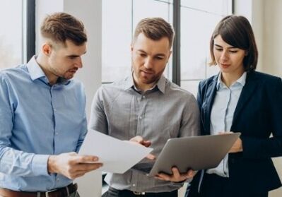 three colleagues reviewing documents together 